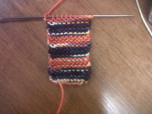 This little rectangle of garter stitch will become the sole of the bootie. Like those Bronco colors?